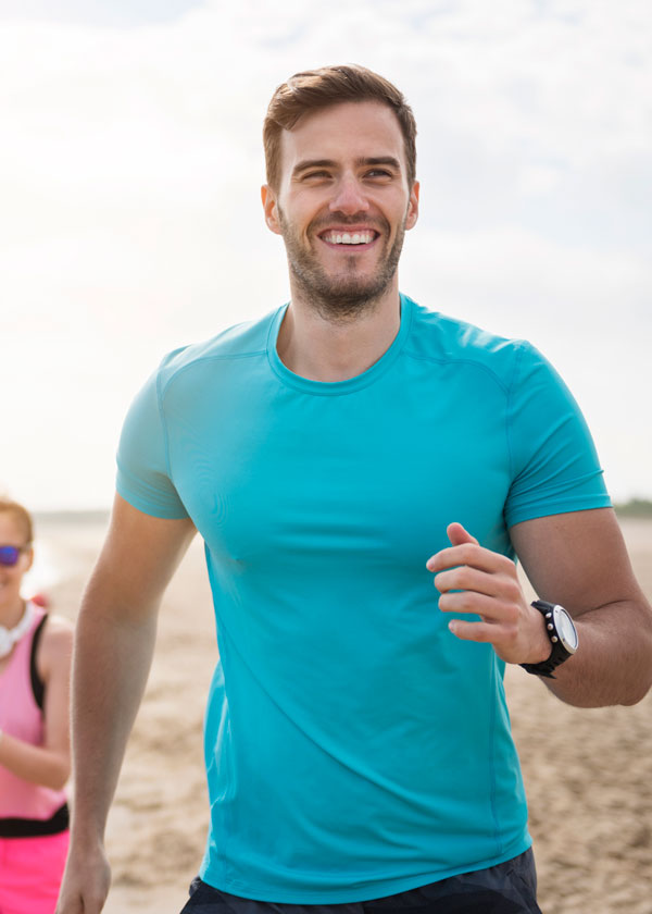 Fit male running on the beach