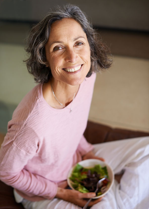 Mature woman eating a salad