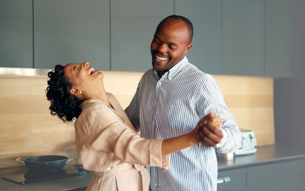Happy couple dancing in kitchen